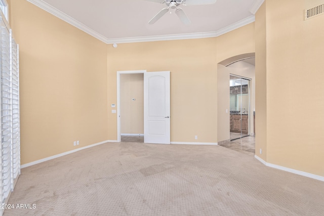 unfurnished room featuring ceiling fan, ornamental molding, and light carpet