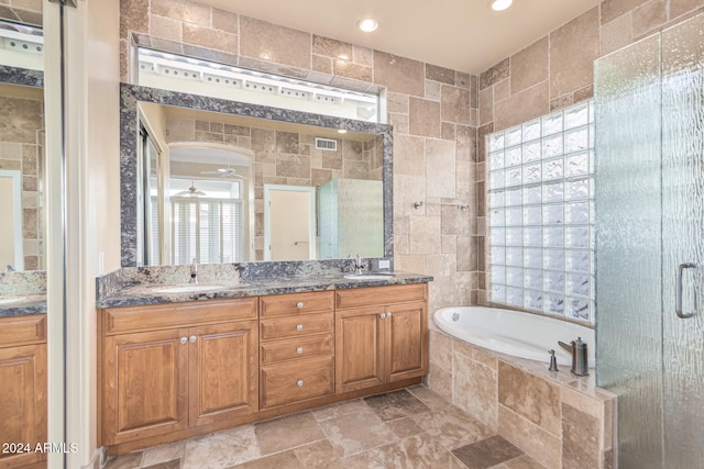 bathroom with vanity, tile walls, independent shower and bath, and ceiling fan