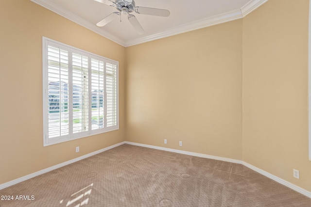 empty room featuring ceiling fan, light colored carpet, and crown molding