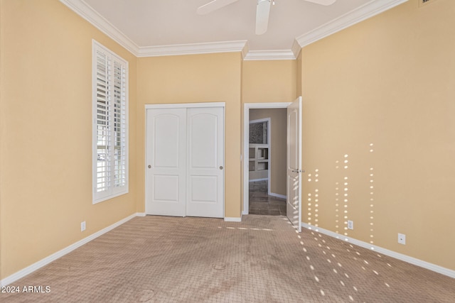 unfurnished bedroom featuring carpet, a closet, and crown molding