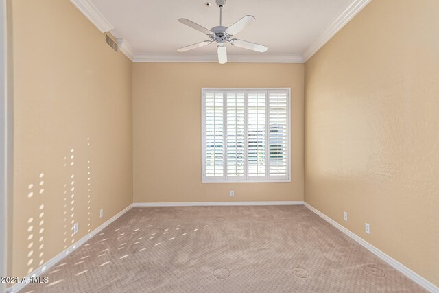 empty room with light carpet, ceiling fan, and ornamental molding