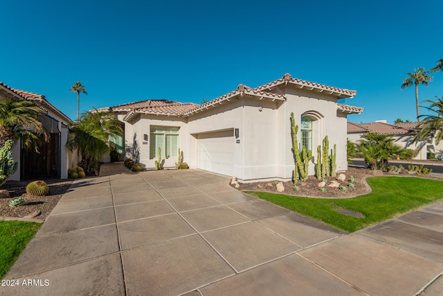 mediterranean / spanish-style house featuring a garage