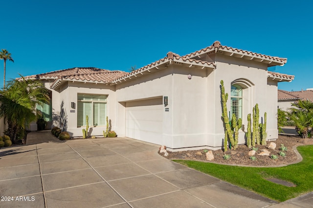 mediterranean / spanish-style home with a garage