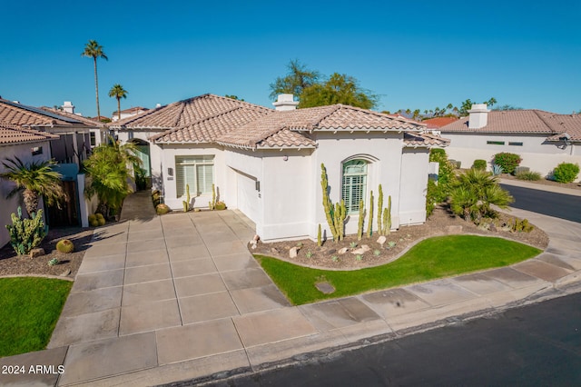 mediterranean / spanish home featuring a garage