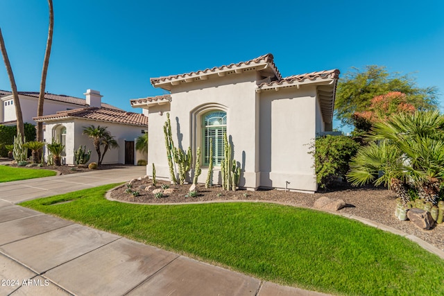 mediterranean / spanish home featuring a front yard