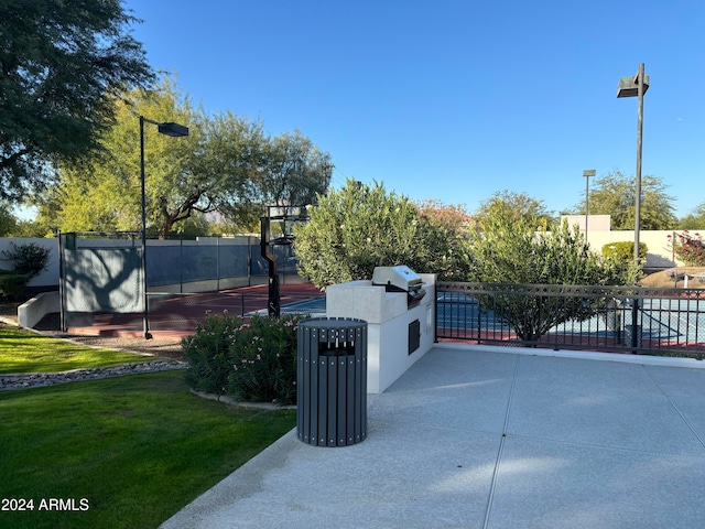 view of gate with a yard