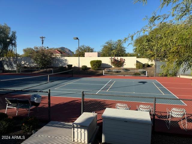 view of tennis court featuring basketball court