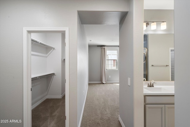 1823 E Chelsea Ln Unit 106, Gilbert, AZ 85295 - bathroom featuring vanity, a spacious closet, and baseboards