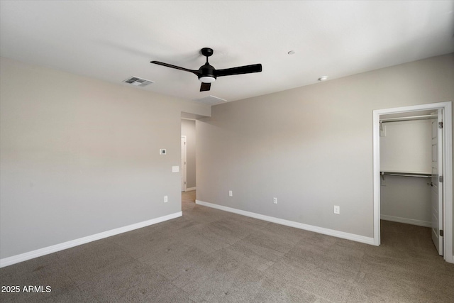 1823 E Chelsea Ln Unit 106, Gilbert, AZ 85295 - unfurnished bedroom with carpet floors, baseboards, a spacious closet, a ceiling fan, and a closet