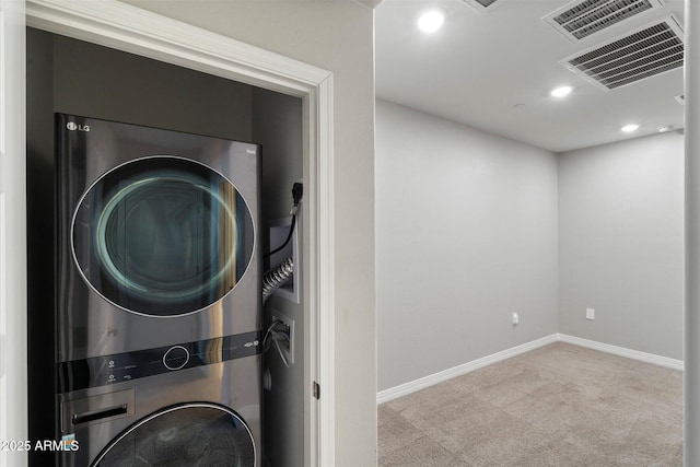 1823 E Chelsea Ln Unit 106, Gilbert, AZ 85295 - laundry room featuring estacked washer and dryer, carpet, baseboards, and recessed lighting