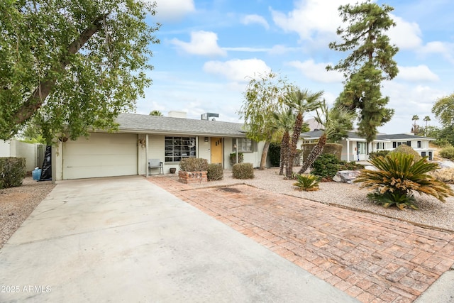 single story home with an attached garage and concrete driveway