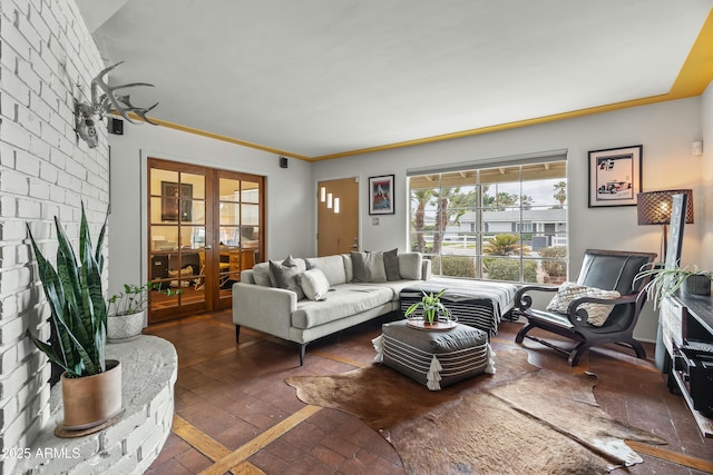 living area featuring brick floor and french doors