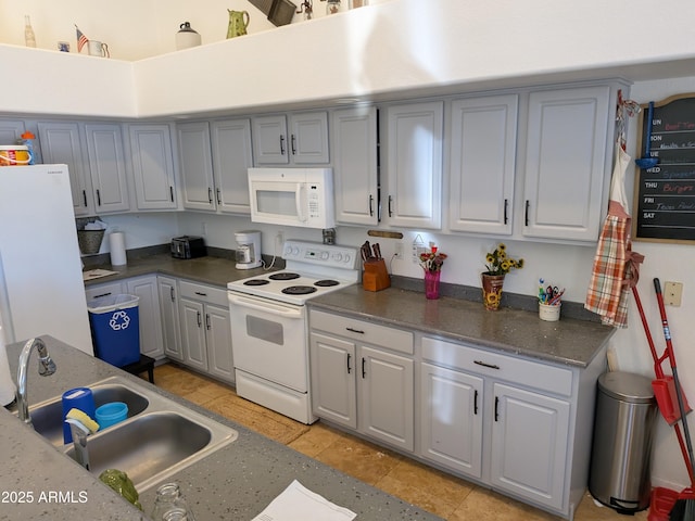 11424 S Obispo Dr, Goodyear, AZ 85338 - kitchen featuring white appliances, gray cabinetry, a sink, and dark countertops