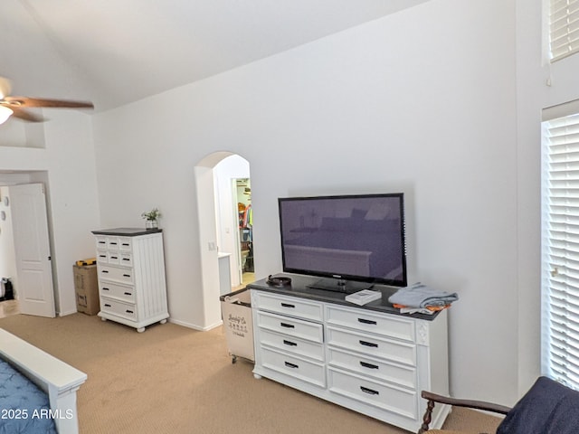 11424 S Obispo Dr, Goodyear, AZ 85338 - living room with light colored carpet, arched walkways, ceiling fan, and lofted ceiling