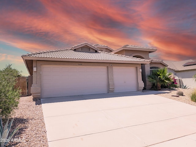 11424 S Obispo Dr, Goodyear, AZ 85338 - view of front of home featuring stucco siding, driveway, and a garage