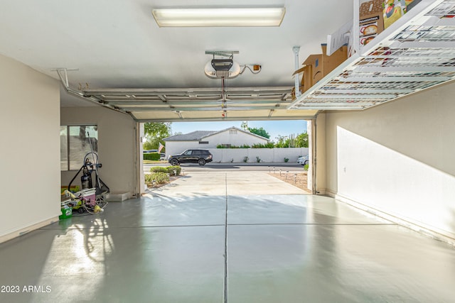 garage with a garage door opener and baseboards