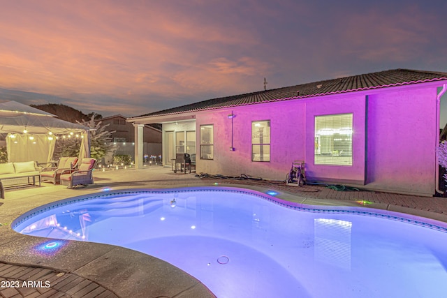 pool featuring a patio and an outdoor hangout area