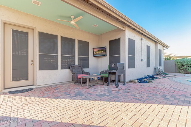 view of patio featuring visible vents, fence, and a ceiling fan