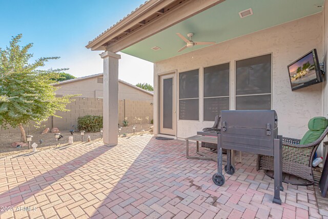 view of patio featuring visible vents, fence, and ceiling fan