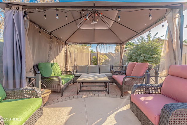 view of patio / terrace with fence, an outdoor hangout area, and a gazebo