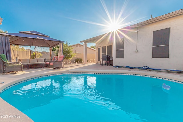 view of pool featuring a fenced in pool, fence, a gazebo, a patio area, and an outdoor living space