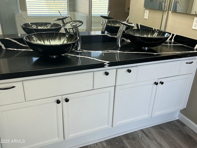 kitchen featuring dark countertops, white cabinets, and dark wood finished floors