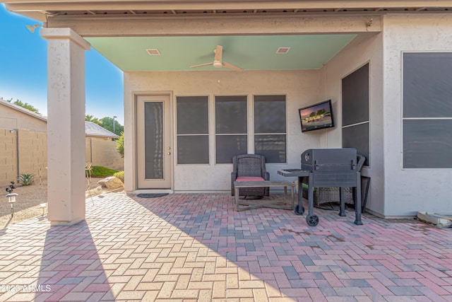 view of patio with a ceiling fan and fence