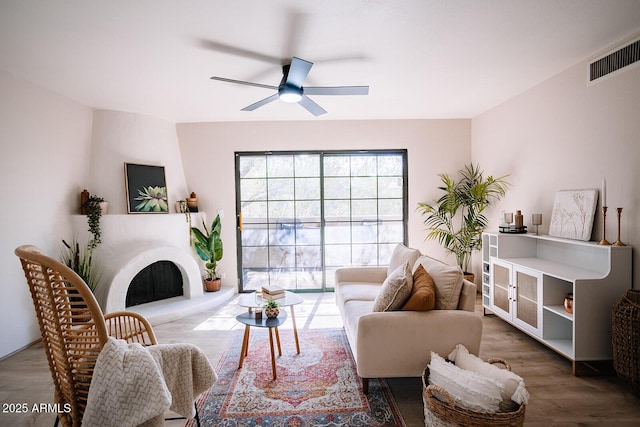 living room with dark wood-type flooring and ceiling fan