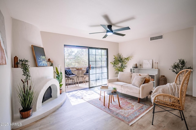 living room featuring hardwood / wood-style flooring and ceiling fan