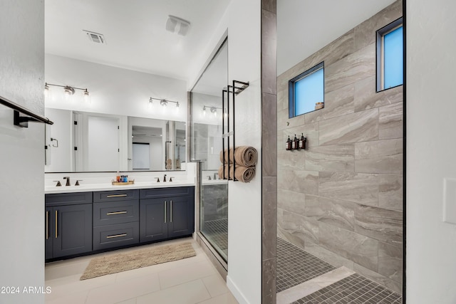 bathroom featuring tile patterned floors, vanity, and tiled shower