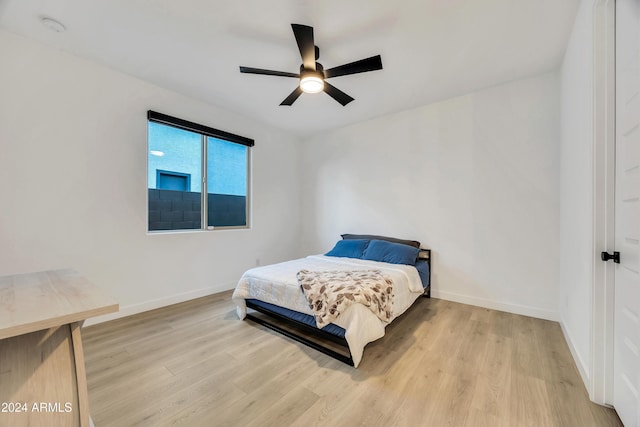 bedroom with ceiling fan and light hardwood / wood-style flooring