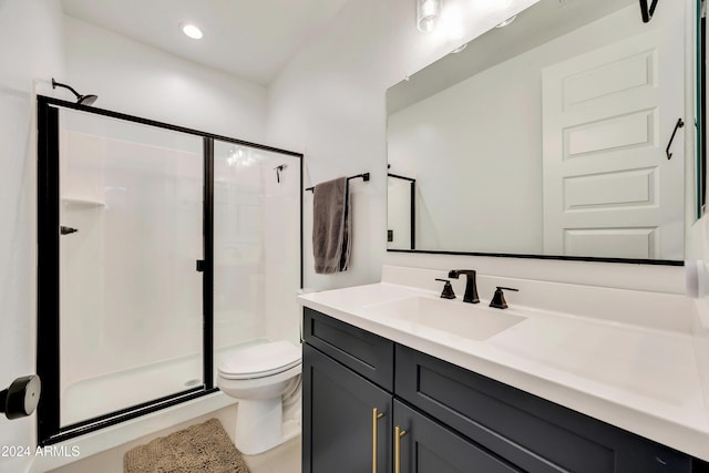 bathroom featuring vanity, toilet, and walk in shower