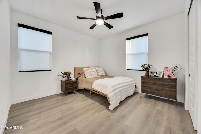 bedroom with ceiling fan and light wood-type flooring