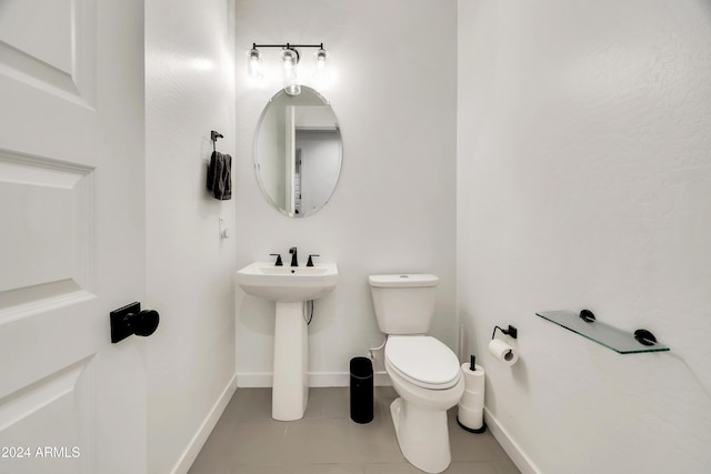 bathroom with sink, tile patterned flooring, and toilet