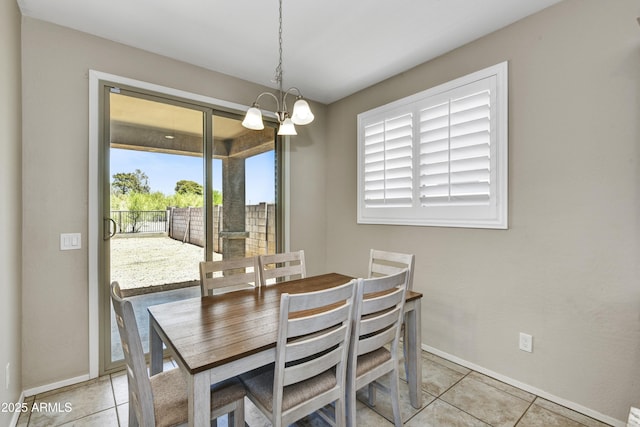 17626 W Paraiso Dr, Surprise, AZ 85387 - dining area with a chandelier, baseboards, and light tile patterned floors