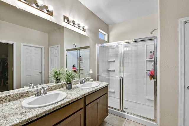 17626 W Paraiso Dr, Surprise, AZ 85387 - bathroom with double vanity, a shower stall, tile patterned flooring, and a walk in closet