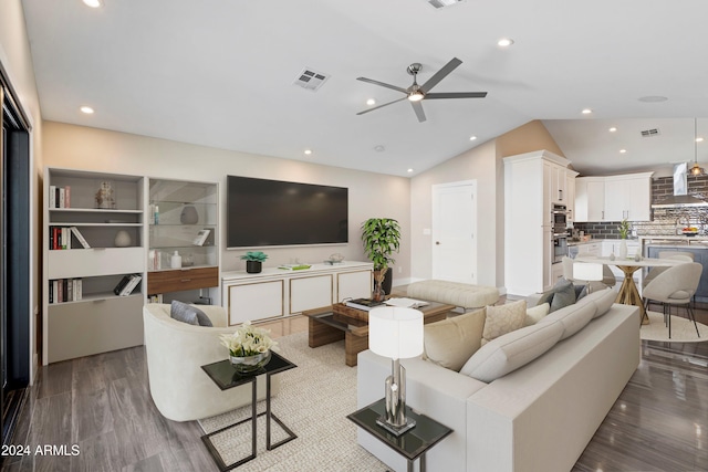 living room with wood-type flooring, vaulted ceiling, and ceiling fan