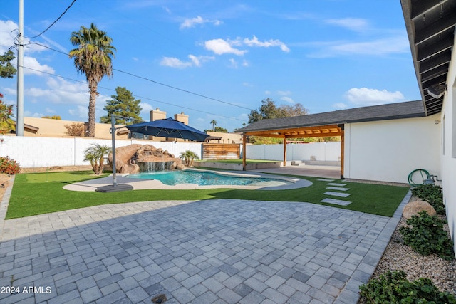 view of swimming pool featuring pool water feature, a patio, and a lawn