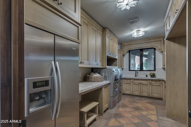 washroom featuring washer and clothes dryer and cabinets