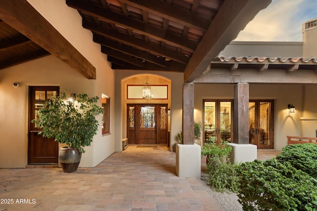 exterior entry at dusk featuring french doors