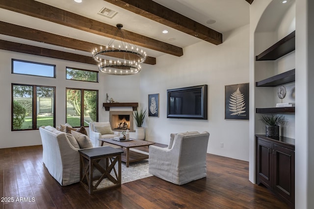 living room with beam ceiling and dark wood-type flooring