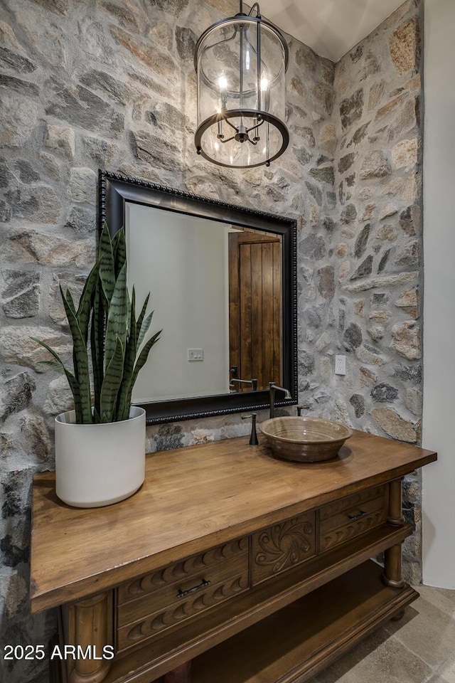 interior details with sink and a chandelier