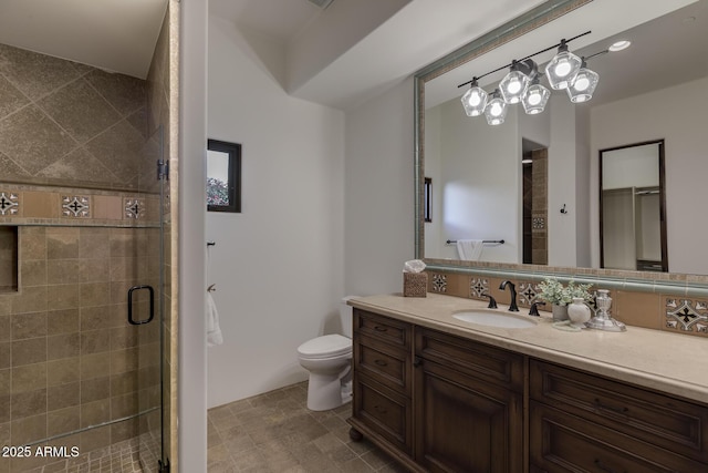 bathroom featuring vanity, toilet, and walk in shower