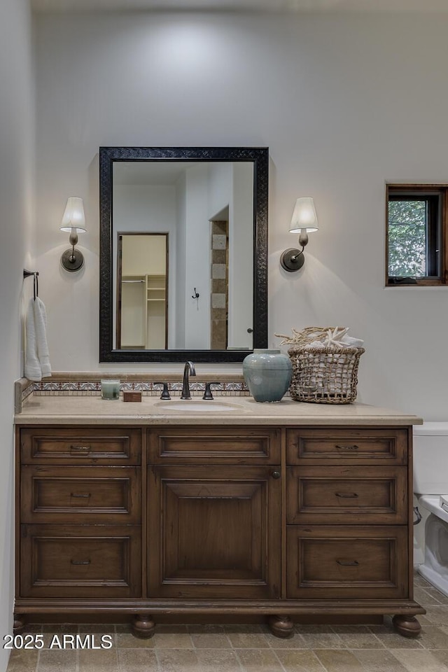 bathroom with vanity and toilet