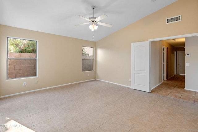 tiled empty room with ceiling fan and lofted ceiling