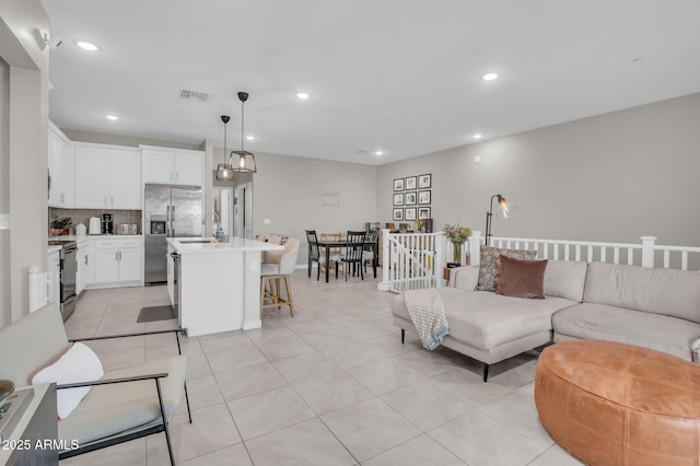 living room featuring recessed lighting, visible vents, and light tile patterned floors