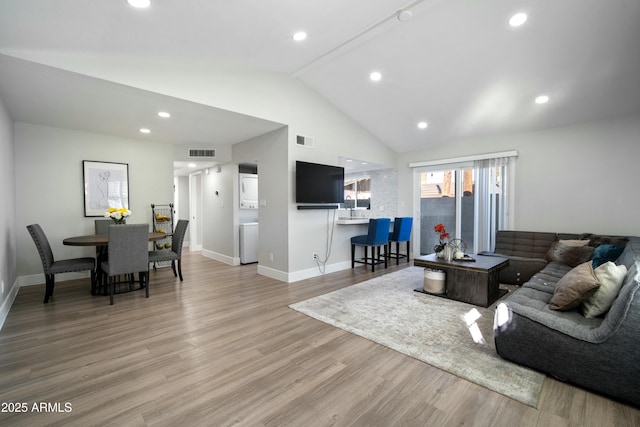 living room with lofted ceiling and light hardwood / wood-style flooring