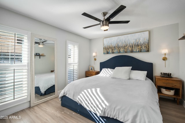 bedroom with ceiling fan and hardwood / wood-style flooring