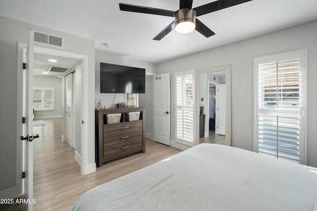 bedroom with light wood-type flooring, ceiling fan, and multiple windows