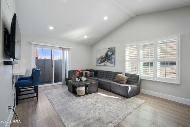 living room with lofted ceiling and light hardwood / wood-style flooring